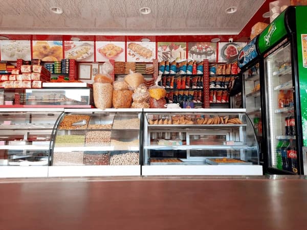 Retail tuck shop counter stocked with bakery items supplied by JBR Gurgaon